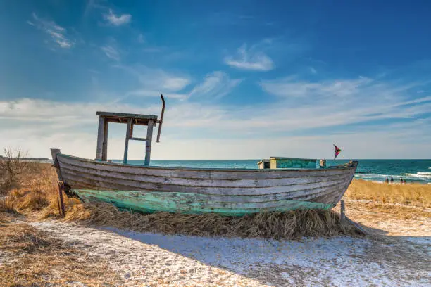 Beautiful old fishing boat on the beach of the Baltic Sea - pier Zingst