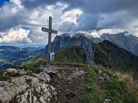 hike to the lütispitz in the alpstein canton of St. Gallen. View of the Santis with the summit cross. wanderlust. High quality photo