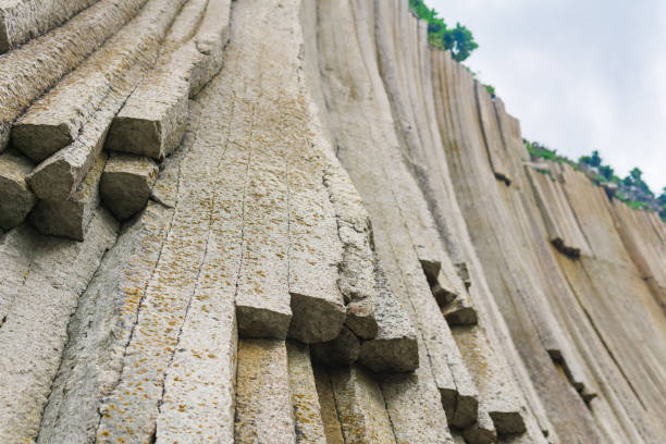 istock basalt columns forming a coastal rock at Cape Stolbchaty on Kunashir Island, close-up 1424958470
