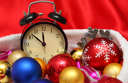 Retro clock and christmas balls and toys in a red bag