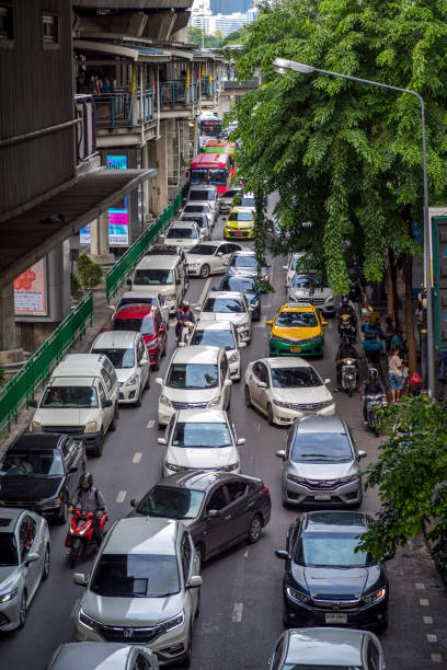 Bangkok, Thailand - September 19, 2019: Cars And People Bustling Along On A Major Roadway In The Downtown Heart Of Bangkok in Silom Road under the BTS skytrain elevated railroad