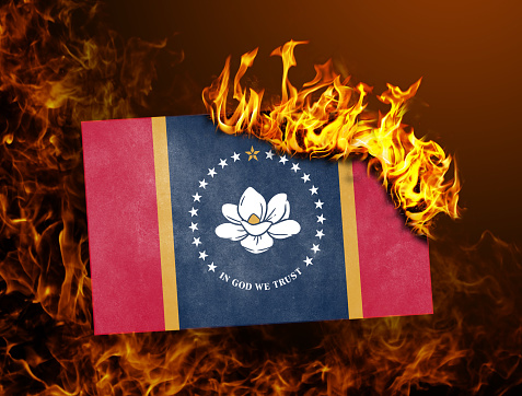 New flag of the US state of Mississippi, in flames - Concept of protesting