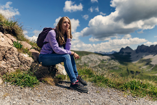 Teenage girl hiking in the high Austrian mountains - Alps, Tyrol, Austria.