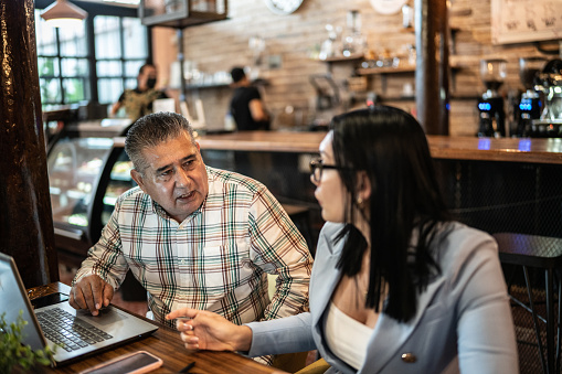 Colleagues having a business meeting in a restaurant