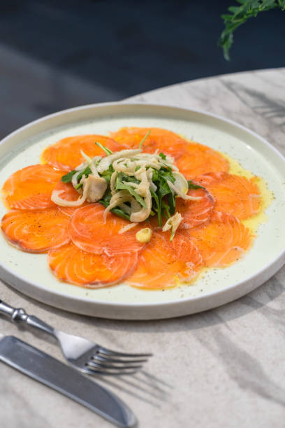 istock Salmon slices on plate with herbs. Selective focus. 1424972118