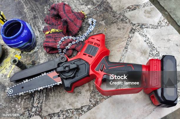 Cordless Mini Electric Chainsaw Stock Photo - Download Image Now - Battery, Blade, Carrying