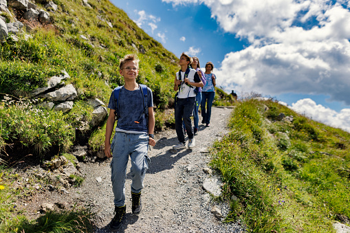 Family hiking in the high Austrian mountains - Alps, Tyrol, Austria. They are walking on the path high in the spectacular Austrian mountains.
Canon R5