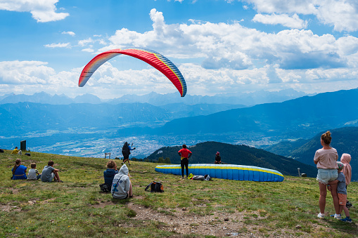 Atibaia, SP, Brazil | April 19, 2019: Man preparing to jump from paraglider in the Pedra Grande (Big Rock) over the city of Atibaia. This place is an important tourist attraction in the state of São Paulo, and it is a famous launch pad for hang-gliders and paragliders.