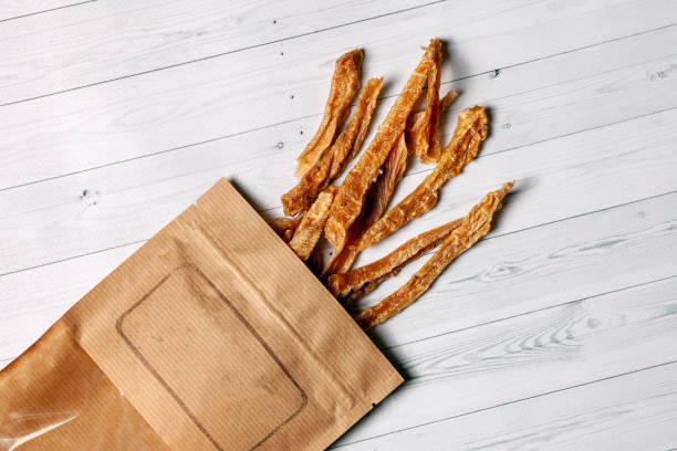 Sliced turkey or chicken meat dehydrated and packed into craft brown paper.