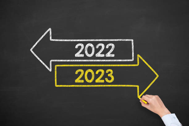 istock Human Hand Drawing Old Year or New Year 2023 on Chalkboard Background 1424977876