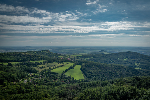 View from Varhost hill and lookout tower there for Ceske Stredohori mountains in summer