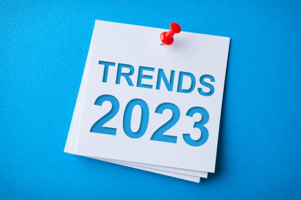 istock Trends 2023 Word in White Sticky Note on Blue Cardboard Background 1424978239