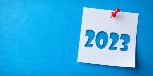 istock White Sticky Note With Happy New Year 2023 And Red Push Pin On Blue Cardboard Background 1424978340