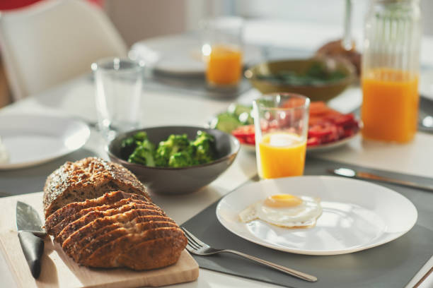 Breakfast with eggs, wholegrain bread, green fresh broccoli, and orange juice stock photo