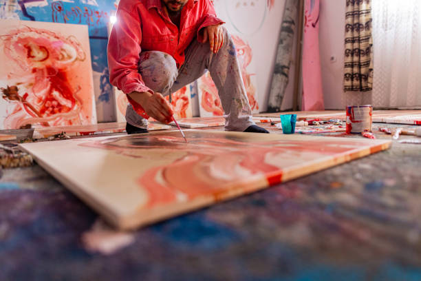 Artist- painter working on painting in studio stock photo