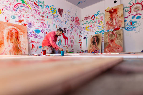 istock Young artist is working on a new canvas in his studio 1424980752