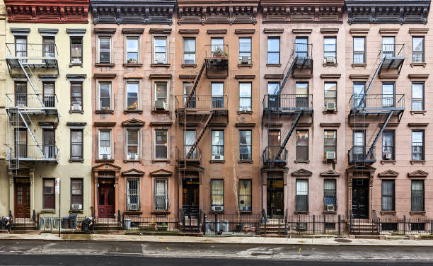 Block of historic apartment buildings crowded together on West 49th Street in the Hell's Kitchen neighborhood of New York City stock photo