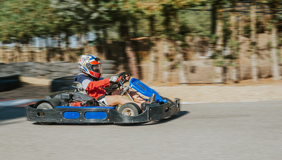 Teenager practicing karting on an autumn day