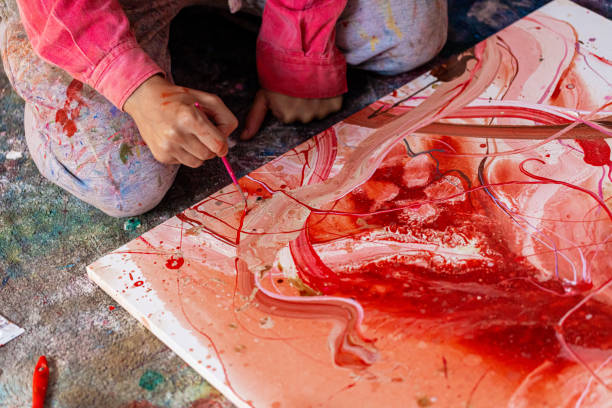 At the messy room, skilled male artist painting