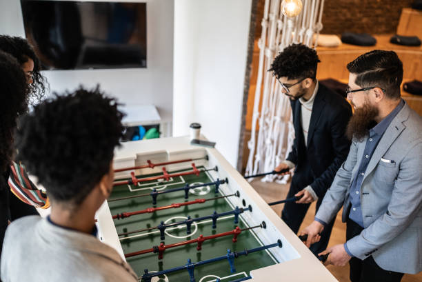 istock Coworkers playing foosball at the office 1424982669