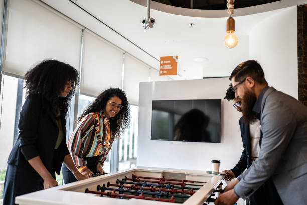 istock Coworkers playing foosball at the office 1424982679