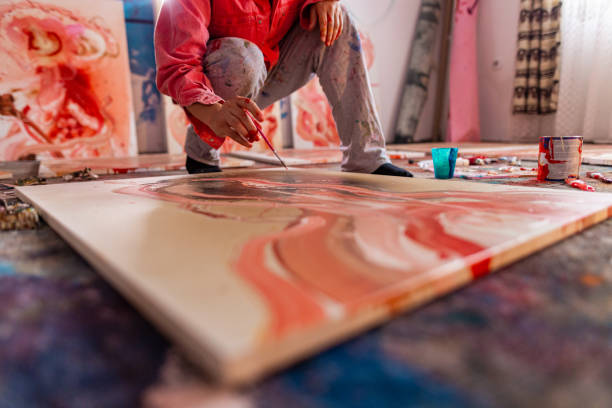 istock Artist- painter working on painting in studio 1424982970