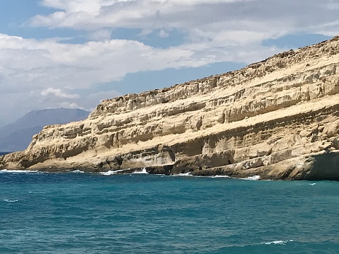 Greece - Crete- Matala Beach It is a beautiful sandy beach sheltered by cliffs caves, troglodyte tombs, carved into the rock, traditions of the Stone Age as well as a small tourist village