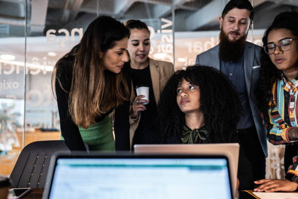 istock Coworkers doing a meeting using laptop and talking at the office 1424985047