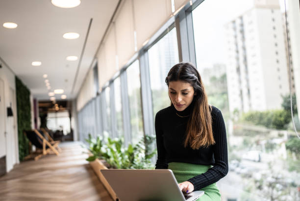 istock Young woman using the laptop at the office 1424986476