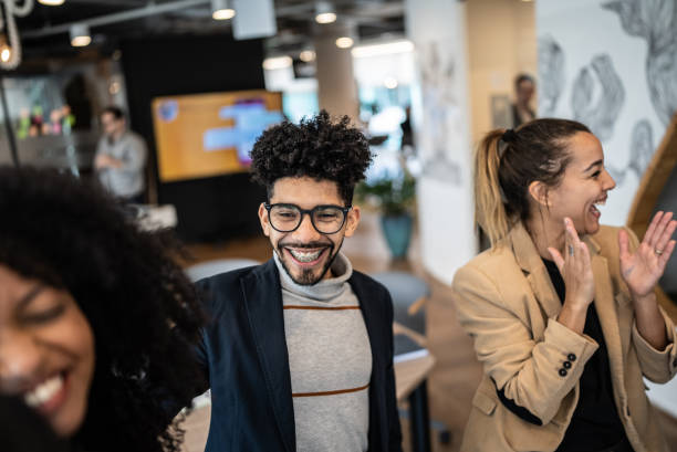 istock Coworkers celebrating at the office 1424986640