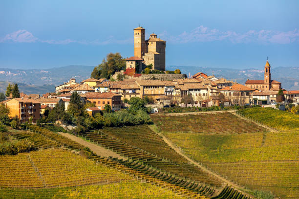 Small town on the hill with autumnal vineyards in Italy. stock photo