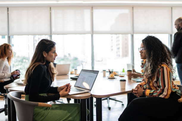istock Coworkers talking in the office 1424987815