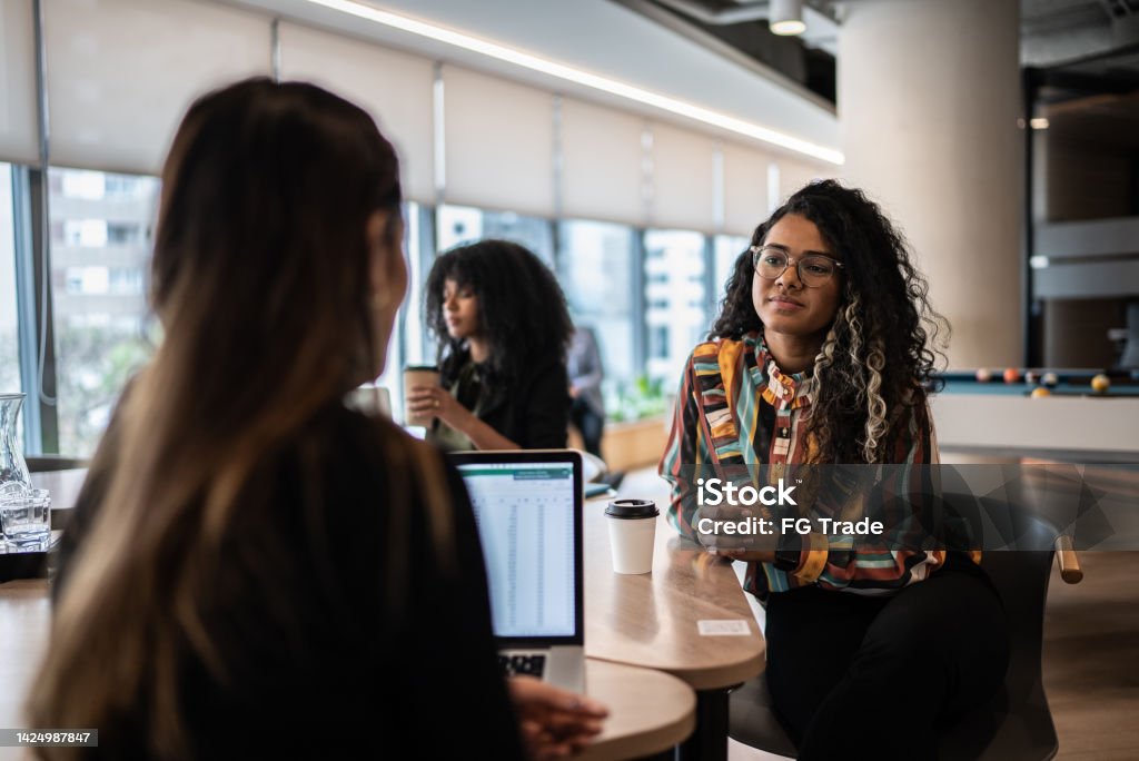 Coworkers talking in the office Trainee Stock Photo