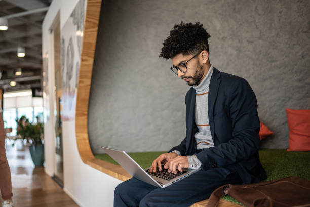 istock Mid adult man using the laptop at the office 1424987885