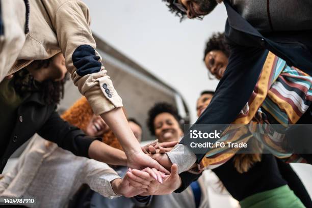 Coworkers With Stacked Hands At The Office Stock Photo - Download Image Now - Community, Diversity, Multiracial Group