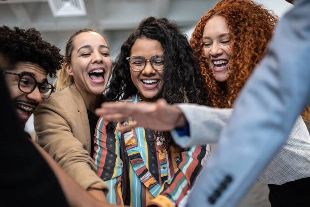 istock Coworkers with stacked hands at the office 1424987930