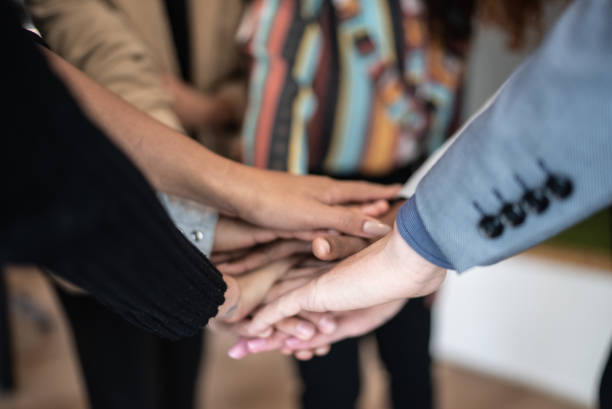 istock Coworkers with stacked hands at the office 1424987968