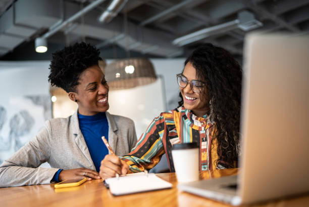 istock Coworkers talking in the office 1424988698