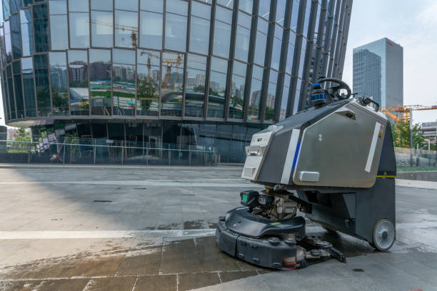 automatic AI cleaner mopping floor outside of modern office building. stock photo