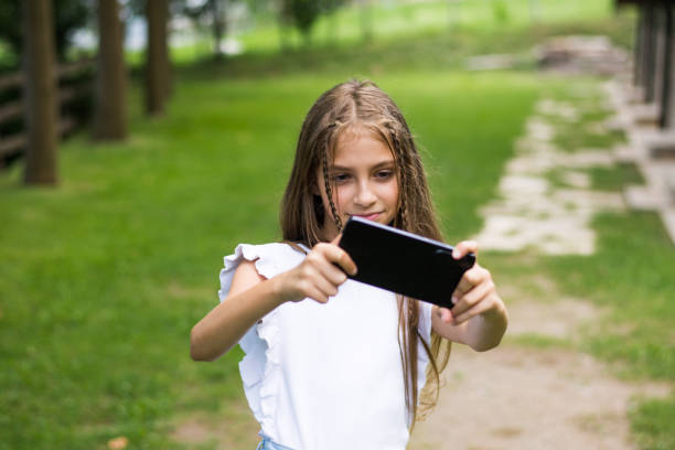 istock Cute girl taking selfie 1424991308