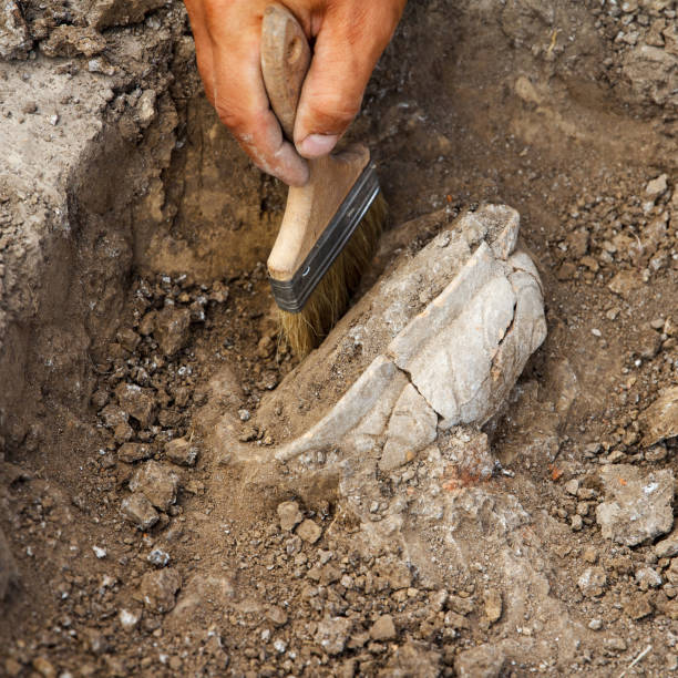 istock Archaeological excavations, archaeologists work, dig up an ancient clay artifact with special tools 1424991886
