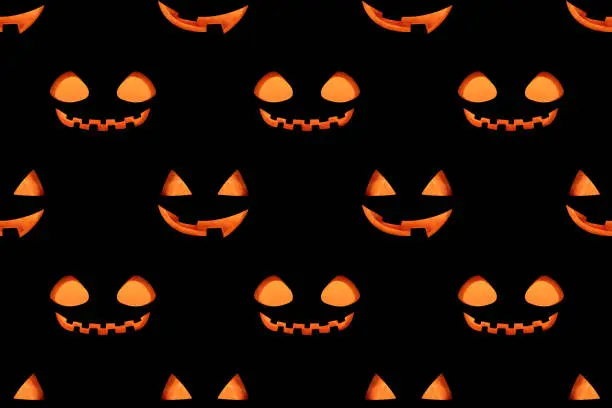 Photo of Seamless pattern with a glowing jack lantern smile on a black background. Jack o lantern pumpkin head background.