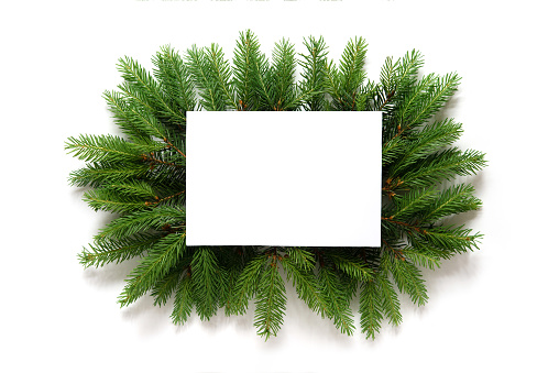Christmas background, pine branches festive background. Creative composition with frame and copy space. Christmas decoration on isolated white background