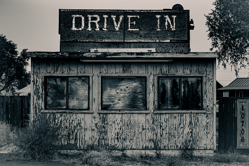 An old abandoned drive in diner sits weathered and rotting