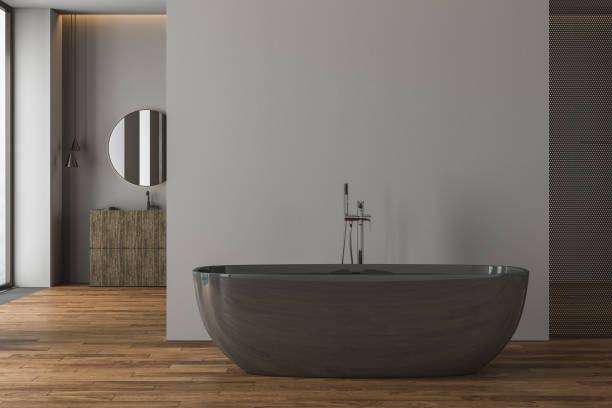 istock Front view on dark bathroom interior with bathtub, large mirror, vanity, panoramic window in reflection, grey walls and parquet floor. 3d rendering 1425013936