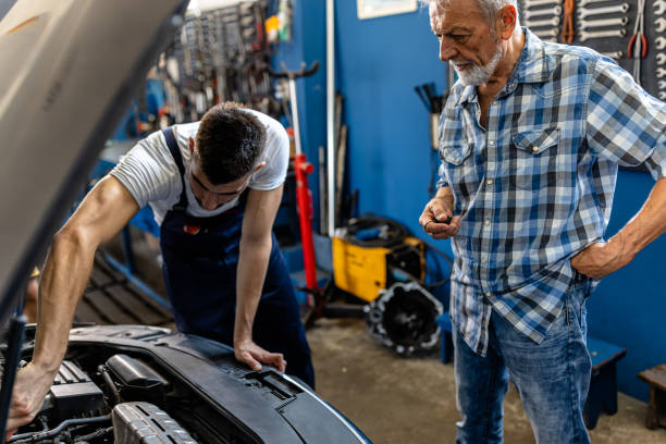 istock A Mechanic Man is Working on the Car Engine Using a Mechanic Equipment while Senior Man is Watching. 1425016479