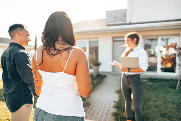 istock real state agent showing the new house 1425019540