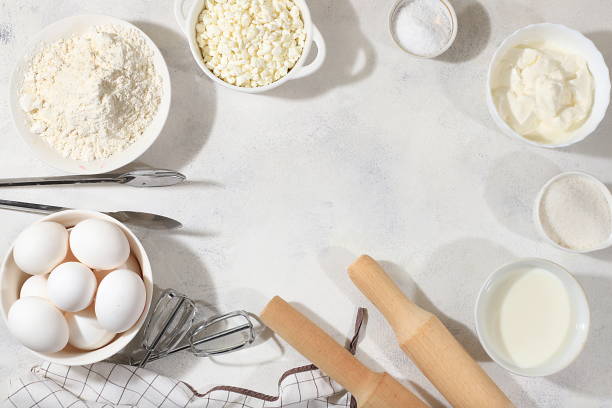 istock Frame for baking and making cake, bread, confectionery and ingredients for cooking, milk, flour, salt, sugar, eggs and cream on a concrete background with space for text 1425021072