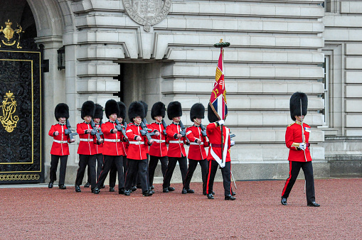Buckingham Palace, London, 2021.  The Mall leading to the Palace and Queen Victoria Monumnet lined with Union Jack Flags and barriers.  Tourists have returned to the capital now that Covid restrictions are softened.