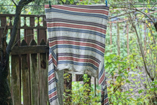 istock one striped wool sweater hangs on a wire on clothespins 1425027981
